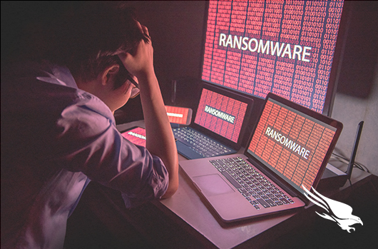 Student Looking At Three Computer Screens With Ransomware